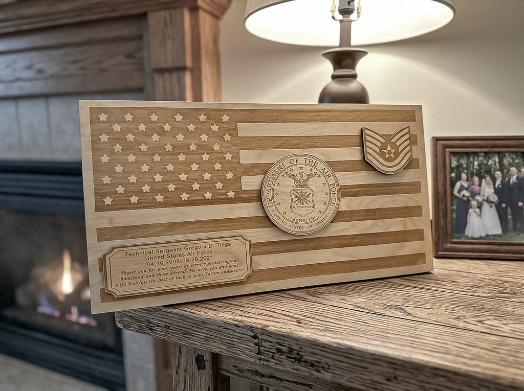 A personalized wooden plaque featuring a laser-engraved American flag design, military rank insignia, a circular 'Department of the Air Force' seal, and a custom text plate, displayed on a rustic wooden table in a cozy living room setting.