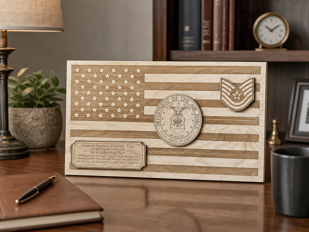 A personalized wooden plaque featuring a laser-etched American flag design, a circular military emblem, and a rectangular engraved nameplate, displayed on a wooden desk in a home office setting.