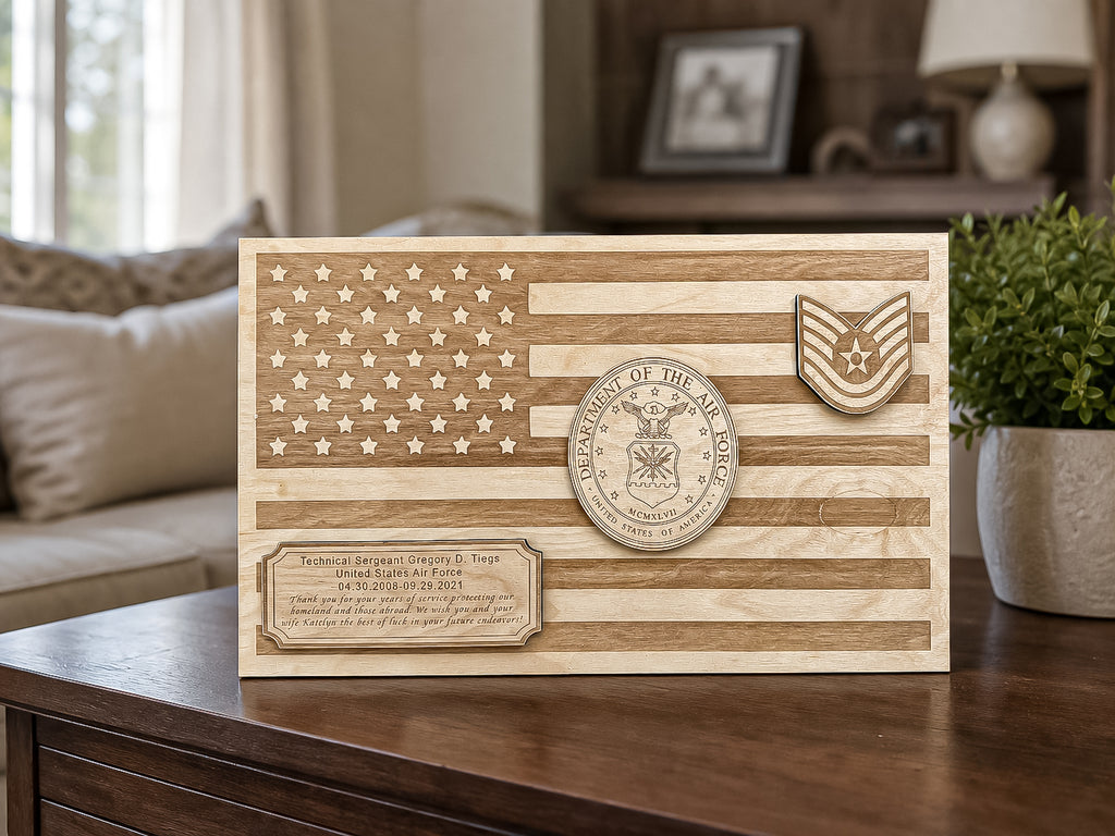 A personalized wooden military memorial plaque featuring a laser-engraved American flag design, a military branch emblem, and a custom text block, displayed on a wooden table in a living room setting.